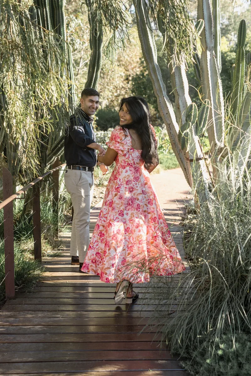 Vanshay and Zahira looking back together on the garden boardwalk